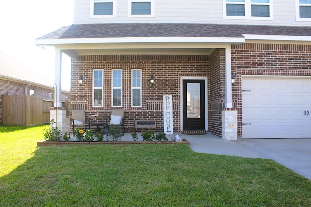 view of front of home featuring a front yard and a garage