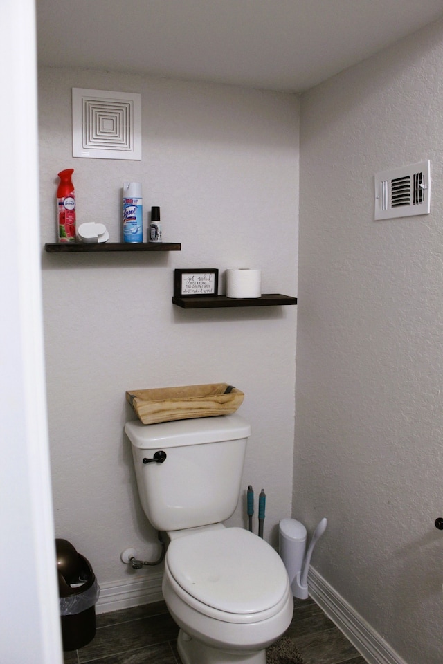 bathroom featuring toilet and hardwood / wood-style flooring