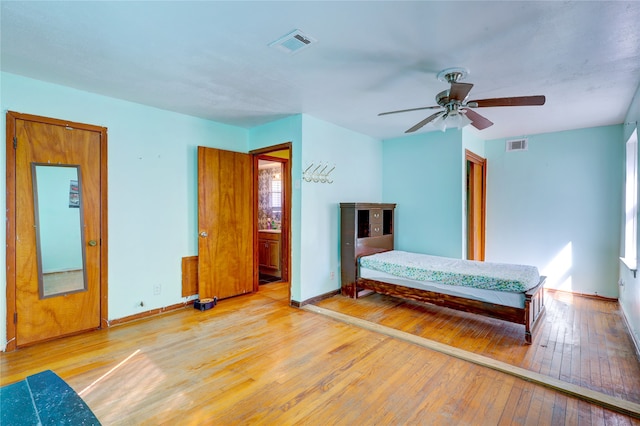 bedroom with light hardwood / wood-style flooring and ceiling fan