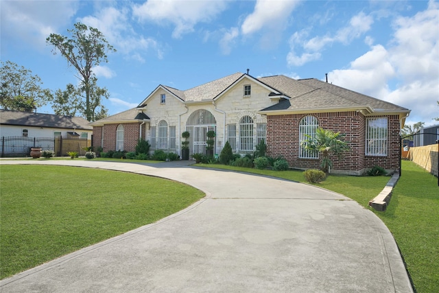 ranch-style home with a front lawn