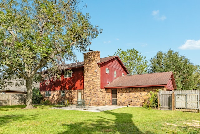 back of house featuring a patio and a lawn