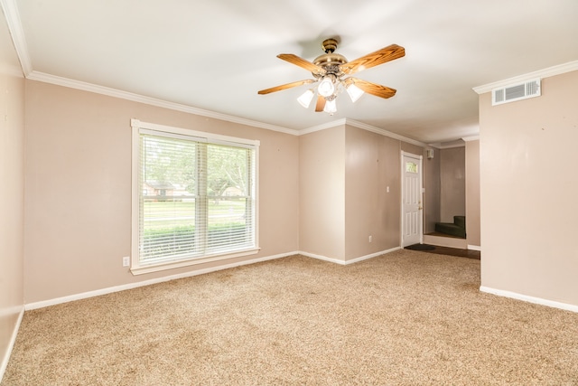 unfurnished room featuring crown molding, light colored carpet, and ceiling fan