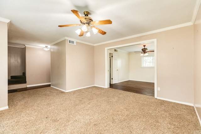 carpeted spare room featuring ornamental molding and ceiling fan