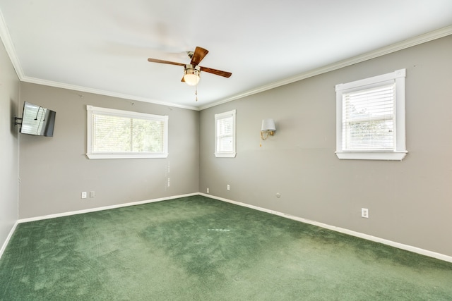 carpeted spare room with crown molding, a healthy amount of sunlight, and ceiling fan