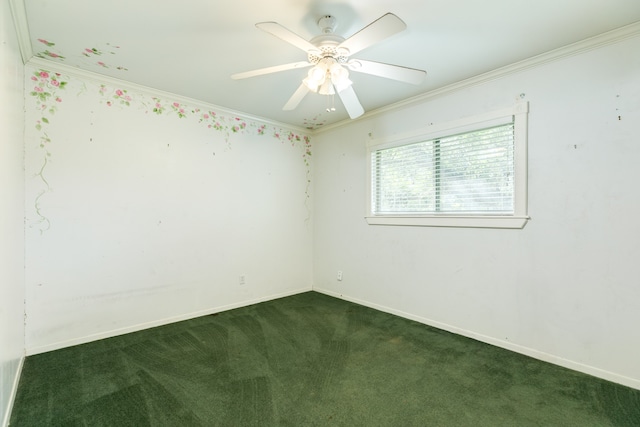 empty room featuring dark carpet, ornamental molding, and ceiling fan