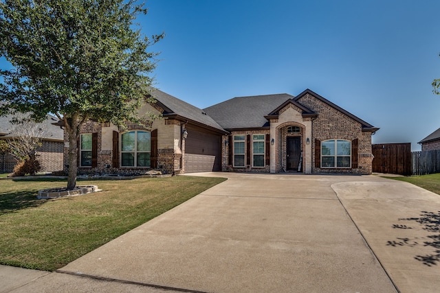 view of front facade with a front yard and a garage