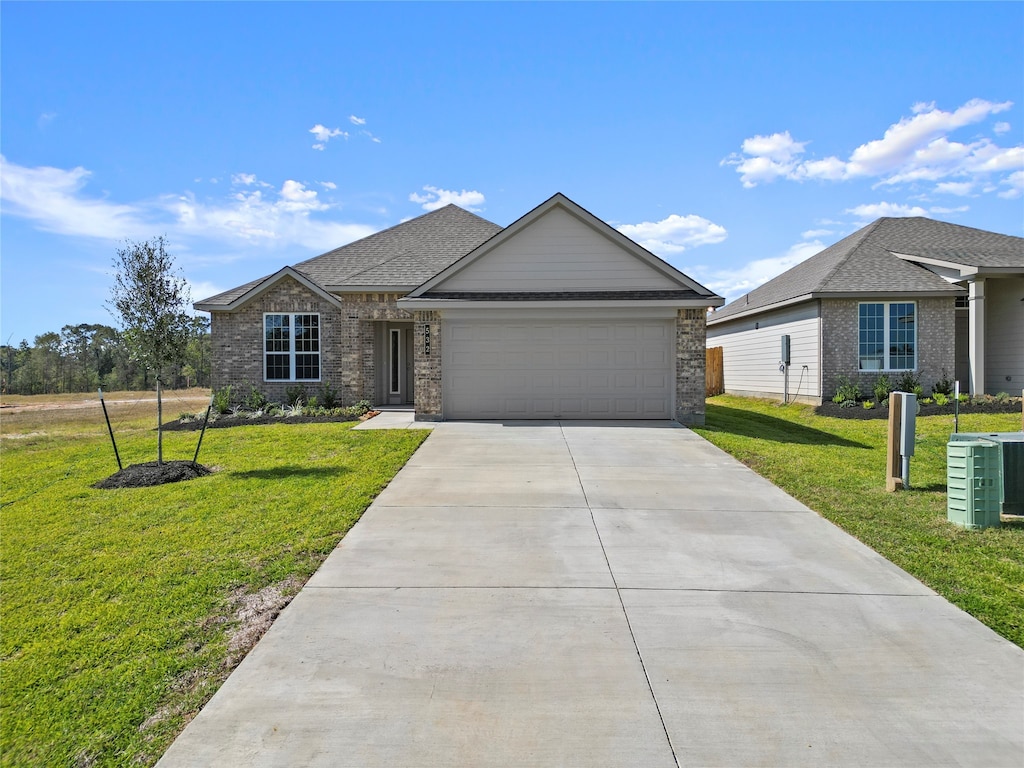 single story home featuring central air condition unit, a front yard, and a garage