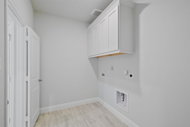 laundry room featuring cabinets, light wood-type flooring, gas dryer hookup, hookup for a washing machine, and electric dryer hookup