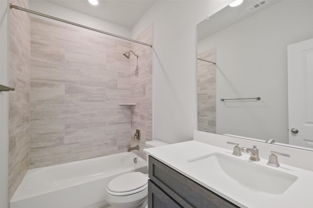 full bathroom with vanity, tiled shower / bath, and toilet