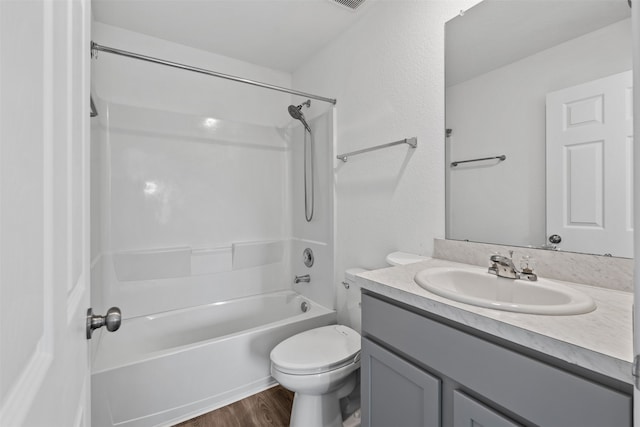 full bathroom with toilet, shower / washtub combination, hardwood / wood-style flooring, and vanity