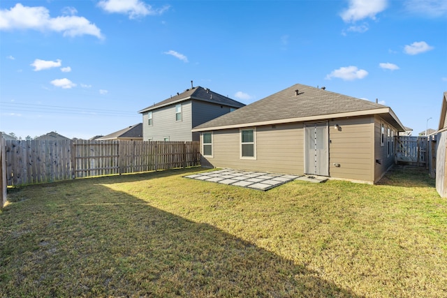 rear view of house with a yard and a patio