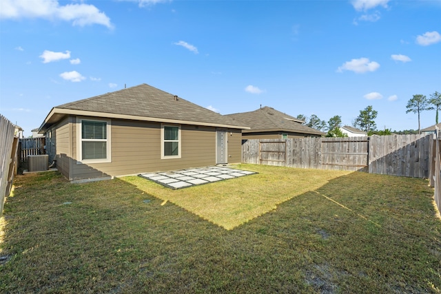 back of house featuring central AC, a yard, and a patio