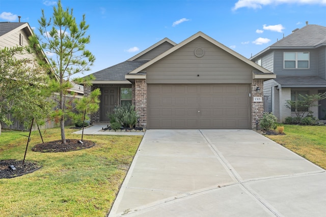 view of front facade with a front yard and a garage