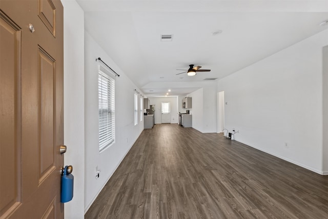 unfurnished living room featuring dark wood-type flooring and ceiling fan