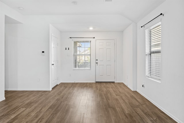 entrance foyer featuring hardwood / wood-style floors and vaulted ceiling