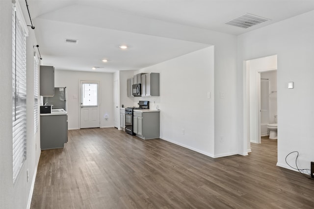 unfurnished living room featuring dark hardwood / wood-style floors and sink