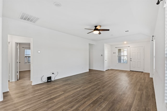 unfurnished living room with dark hardwood / wood-style floors and ceiling fan