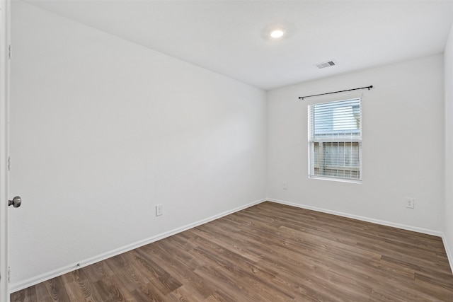 spare room featuring dark hardwood / wood-style flooring