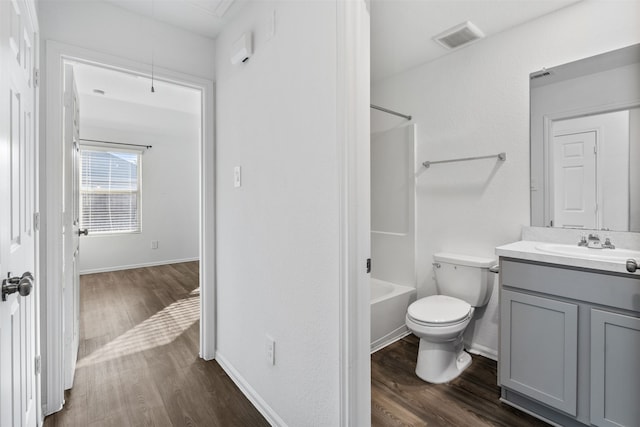 full bathroom featuring vanity, toilet, hardwood / wood-style flooring, and shower / tub combination