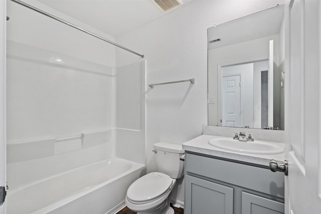 full bathroom with vanity, toilet, and washtub / shower combination