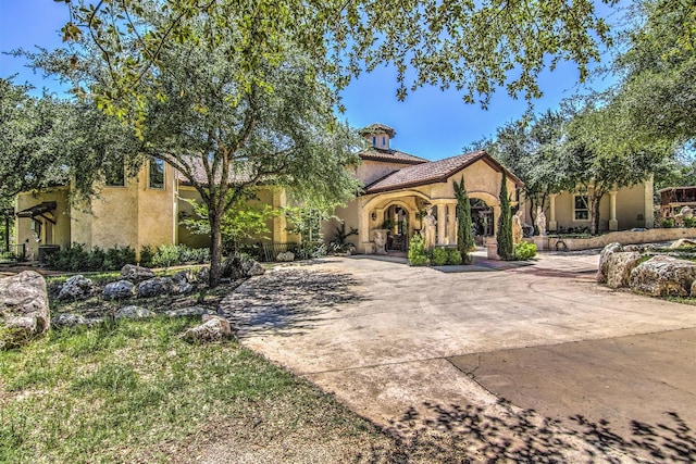 9469 Canyon Mist, Helotes, TX 78023 - mediterranean / spanish-style home featuring stucco siding and curved driveway