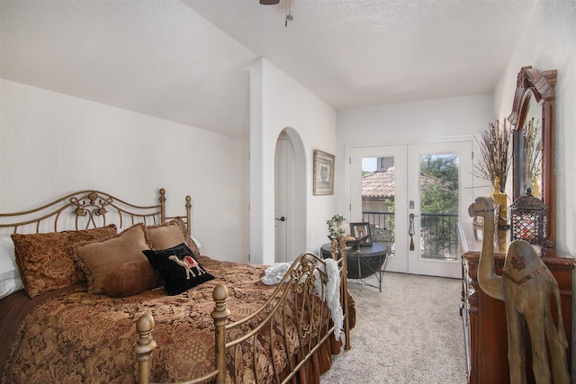 bedroom with french doors, light carpet, and access to outside