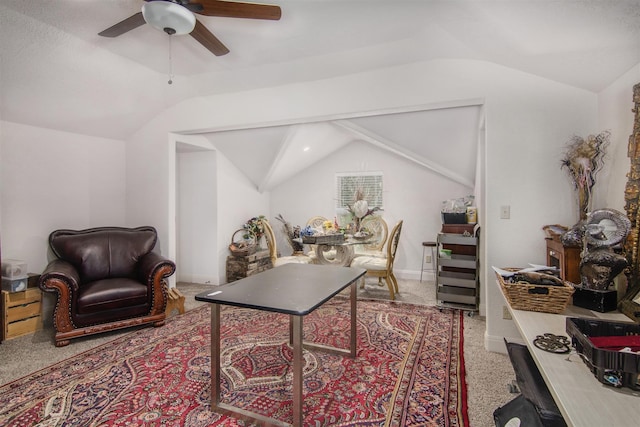 carpeted office featuring lofted ceiling and ceiling fan