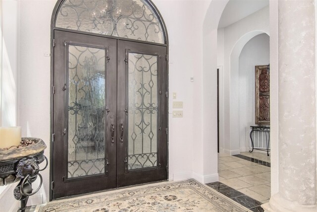 9469 Canyon Mist, Helotes, TX 78023 - tiled foyer featuring french doors, arched walkways, baseboards, and inlaid floor details