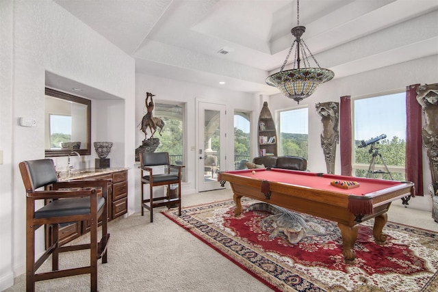 rec room featuring pool table, light carpet, and a tray ceiling