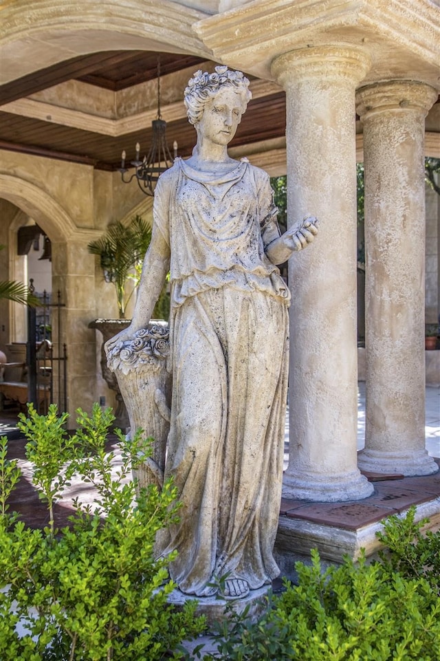 exterior details featuring a chandelier and decorative columns