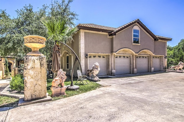 mediterranean / spanish-style house featuring a garage