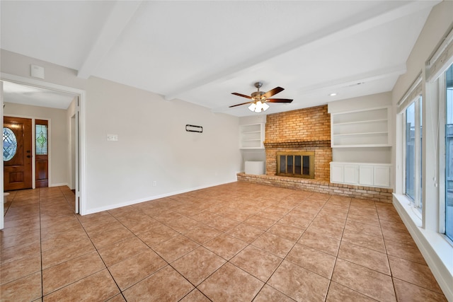 unfurnished living room featuring a fireplace, a healthy amount of sunlight, beamed ceiling, and built in features