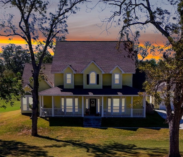 view of front facade featuring a lawn and covered porch