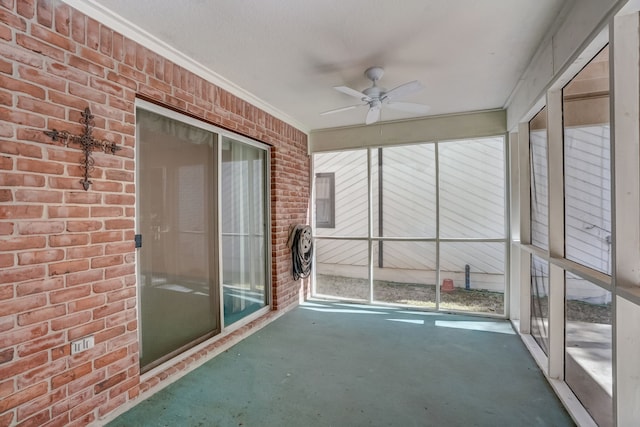 unfurnished sunroom featuring plenty of natural light and ceiling fan