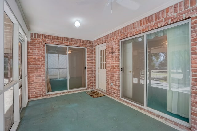 unfurnished sunroom with ceiling fan