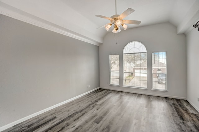 unfurnished room featuring hardwood / wood-style flooring, ceiling fan, and vaulted ceiling