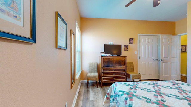 bedroom with a closet, wood-type flooring, and ceiling fan