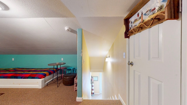 carpeted bedroom with vaulted ceiling