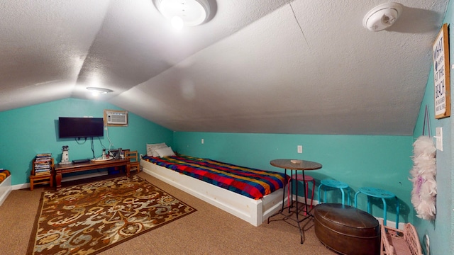 bedroom with a textured ceiling, vaulted ceiling, and carpet floors