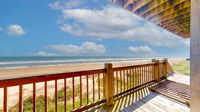 deck with a water view and a beach view