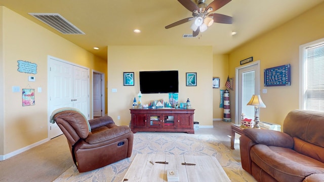 living room featuring ceiling fan and light colored carpet