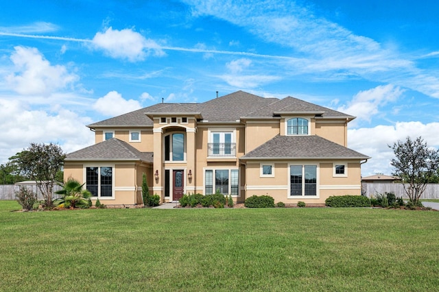 view of front of home featuring a balcony and a front lawn