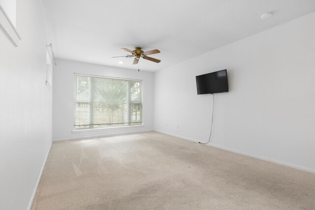 carpeted empty room featuring ceiling fan