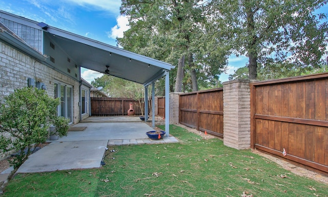 view of yard featuring a patio and ceiling fan