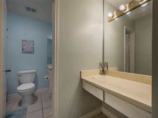 bathroom with vanity, tile patterned floors, and toilet