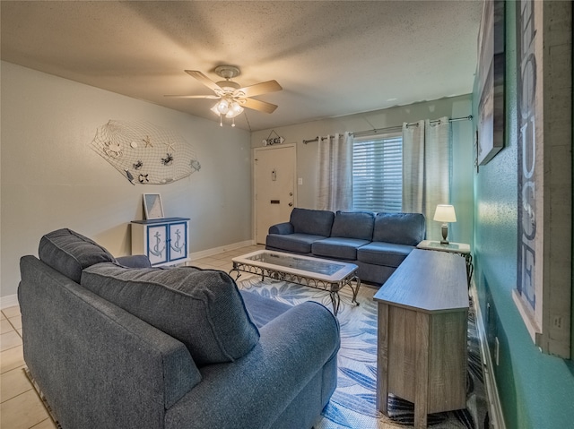 tiled living room featuring a textured ceiling and ceiling fan