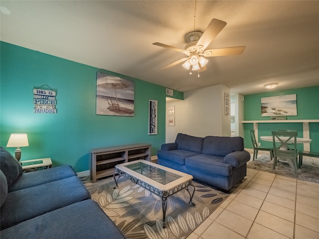 tiled living room featuring ceiling fan