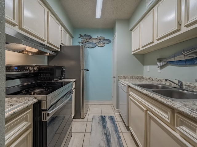 kitchen with a textured ceiling, black appliances, sink, and light tile patterned floors