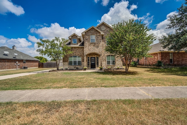 208 Cobblestone Cir, Red Oak, TX 75154 - traditional-style house featuring brick siding, a front lawn, and fence