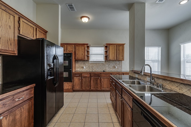 208 Cobblestone Cir, Red Oak, TX 75154 - kitchen with backsplash, visible vents, a sink, black appliances, and brown cabinetry